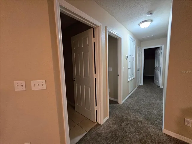 an empty room with entrance and windows