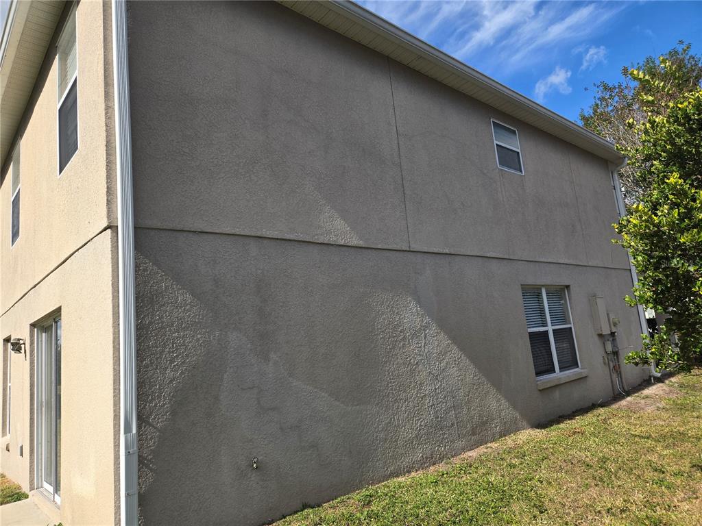 8 Windrose Drive Orlando, FL 32824 - Photo 4 of 23 a bedroom with a bed and potted plants