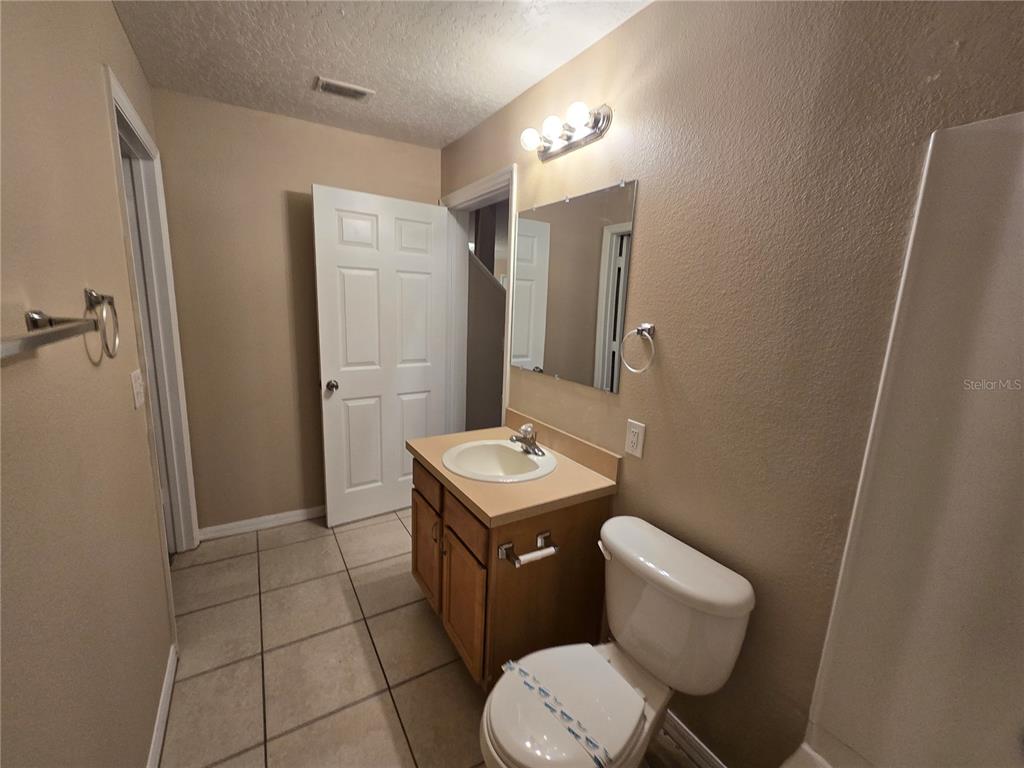 8 Windrose Drive Orlando, FL 32824 - Photo 9 of 23 a bathroom with a toilet sink and mirror