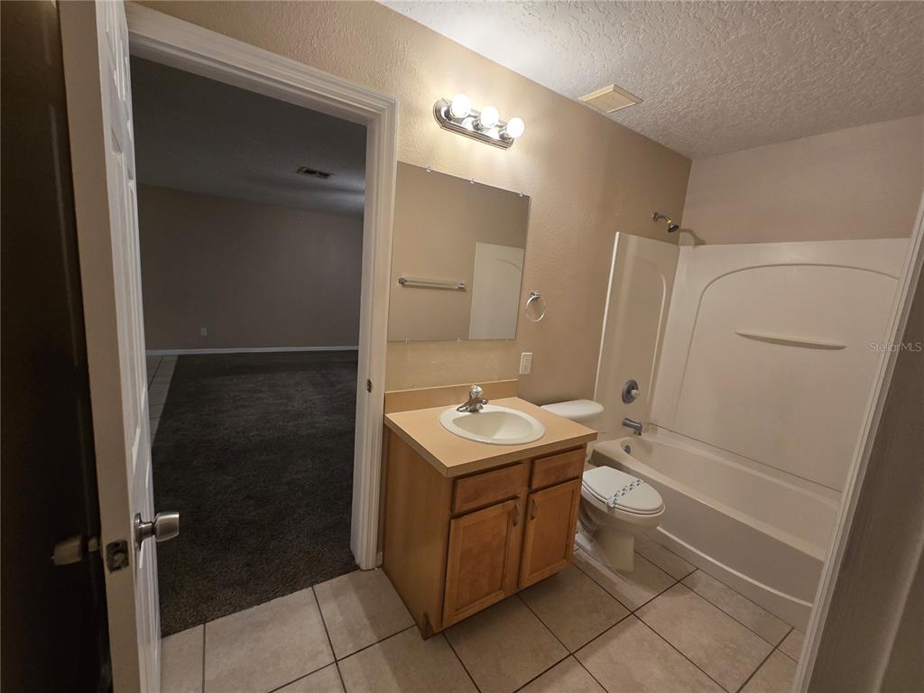 8 Windrose Drive Orlando, FL 32824 - Photo 10 of 23 a bathroom with a sink toilet and shower