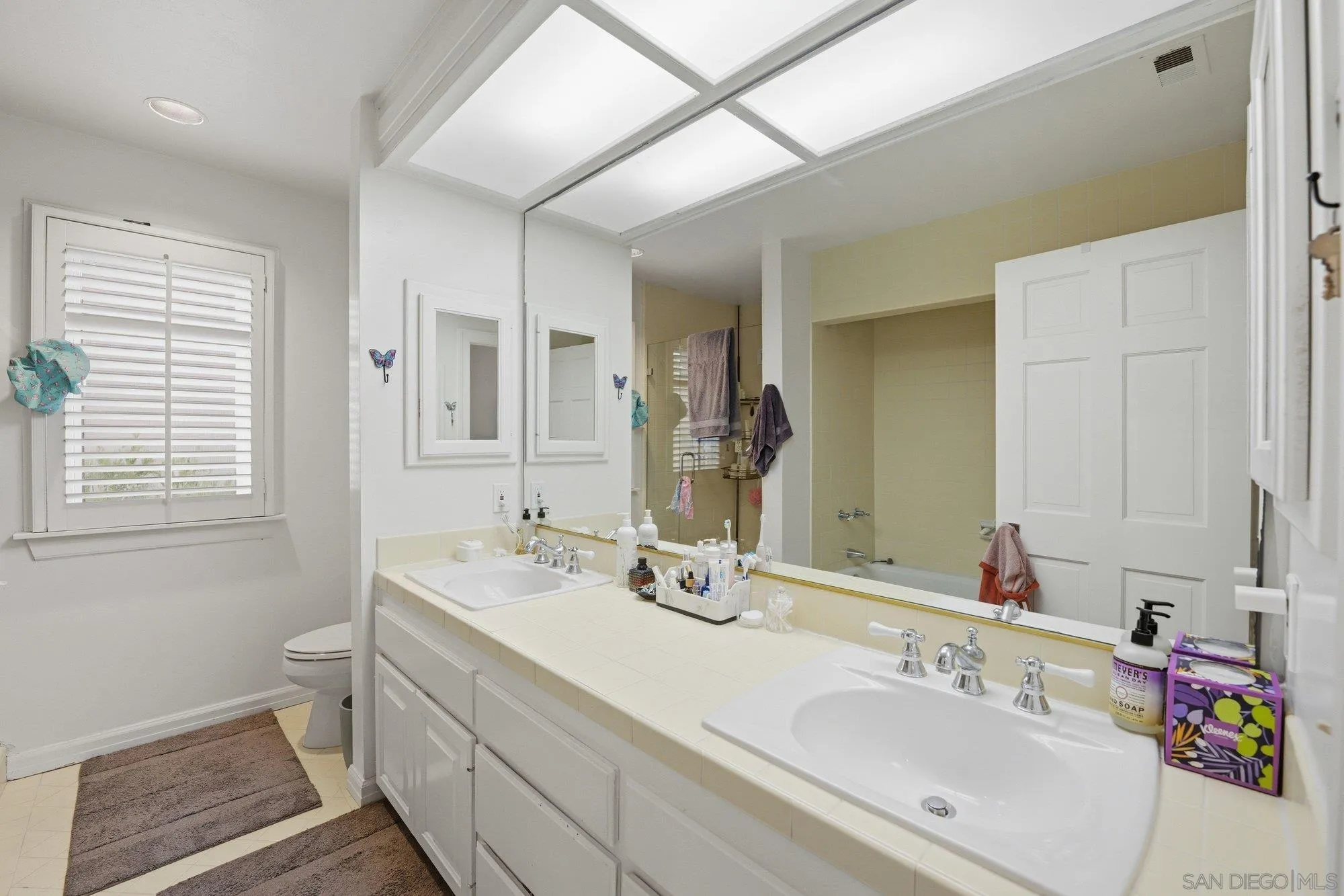 711 Kline Street, Unit A La Jolla, CA 92037 - Photo 13 of 20 a bathroom with a sink and a mirror