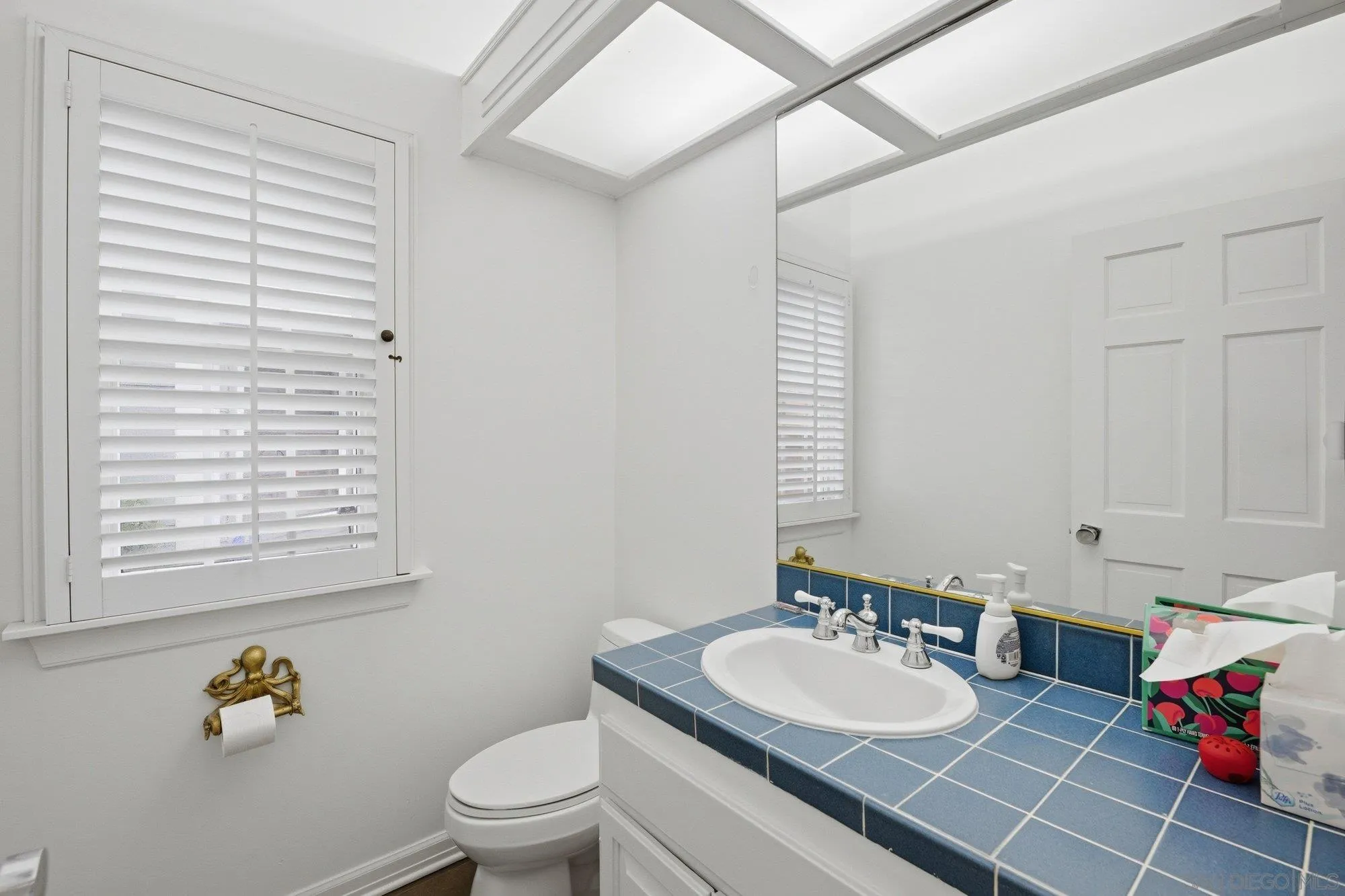 711 Kline Street, Unit A La Jolla, CA 92037 - Photo 15 of 20 a bathroom with a sink vanity mirror and toilet