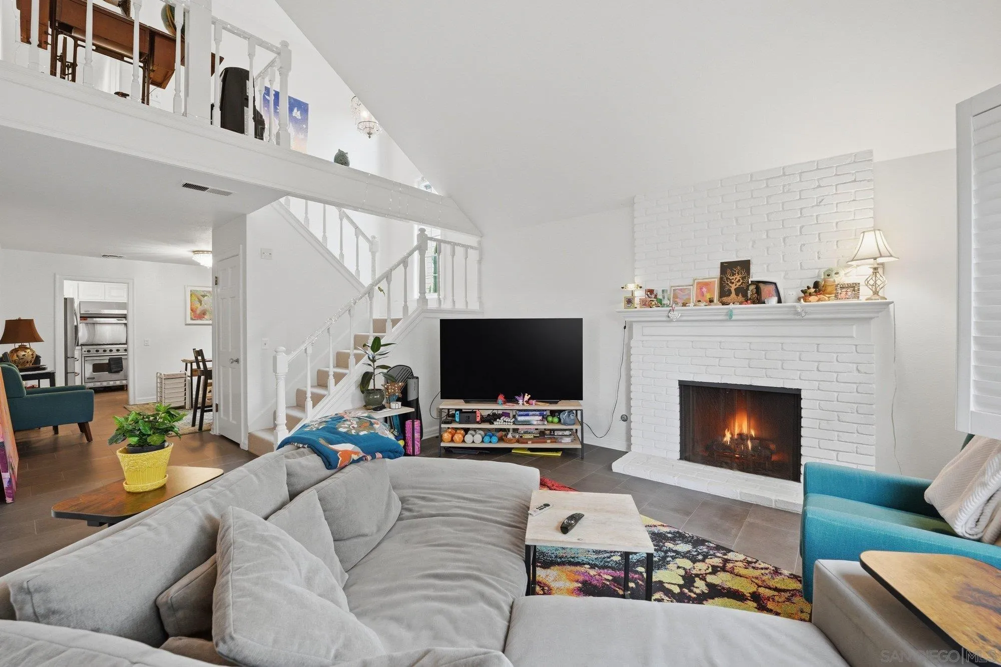 711 Kline Street, Unit A La Jolla, CA 92037 - Photo 3 of 20 a living room with furniture a fireplace and a flat screen tv