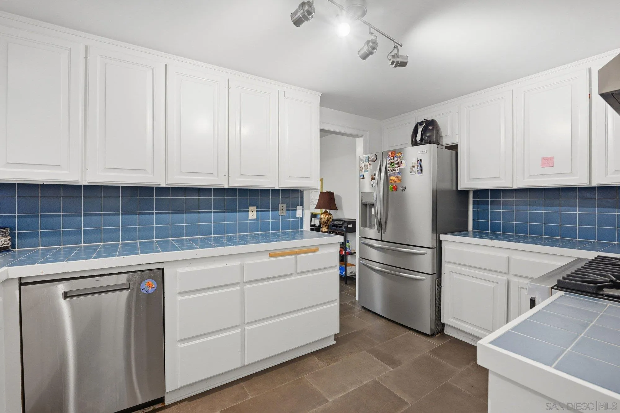 711 Kline Street, Unit A La Jolla, CA 92037 - Photo 7 of 20 a kitchen with white cabinets and white appliances