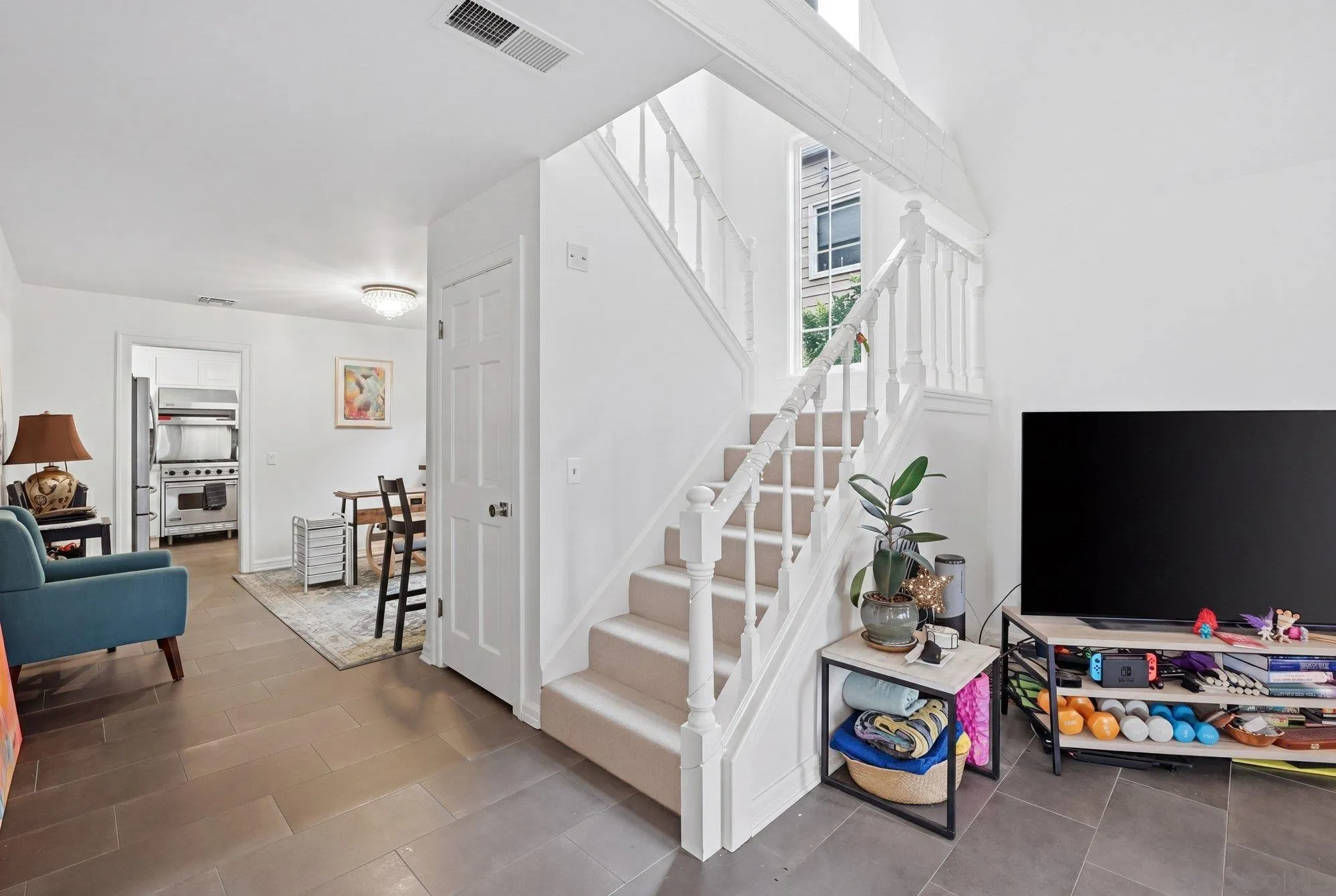 711 Kline Street, Unit A La Jolla, CA 92037 - Photo 9 of 20 a view of a livingroom with furniture and a flat screen tv