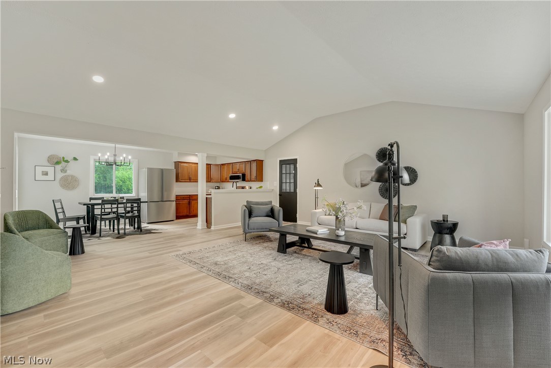 646 Ledge Road Macedonia, OH 44056 - Photo 3 of 28 Spacious living area featuring light wood-finish flooring, vaulted ceilings, recessed lighting, and a neutral wall palette