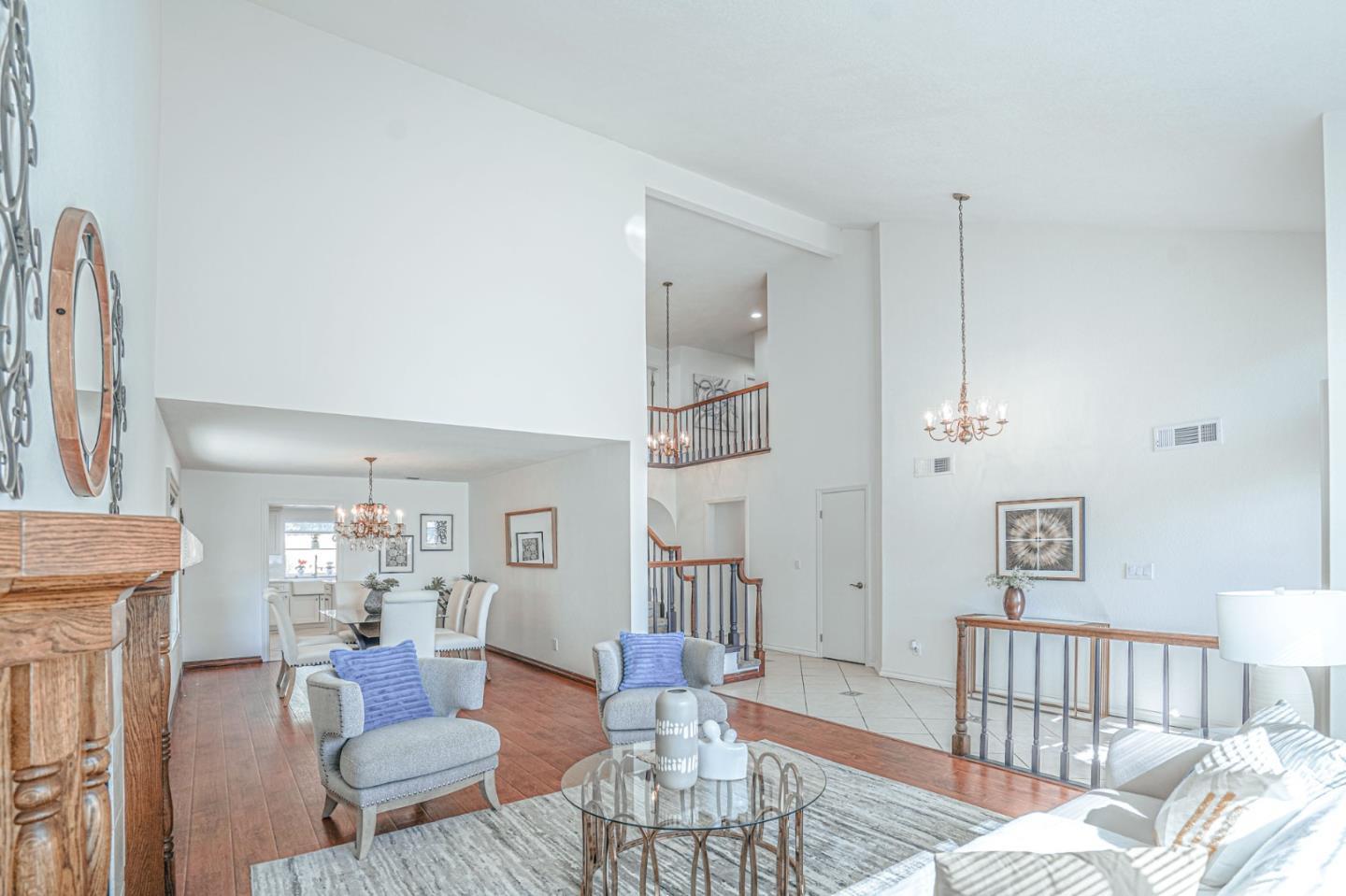 847 Pacheco Drive Milpitas, CA 95035 - Photo 11 of 68 a living room with furniture a fireplace and a chandelier