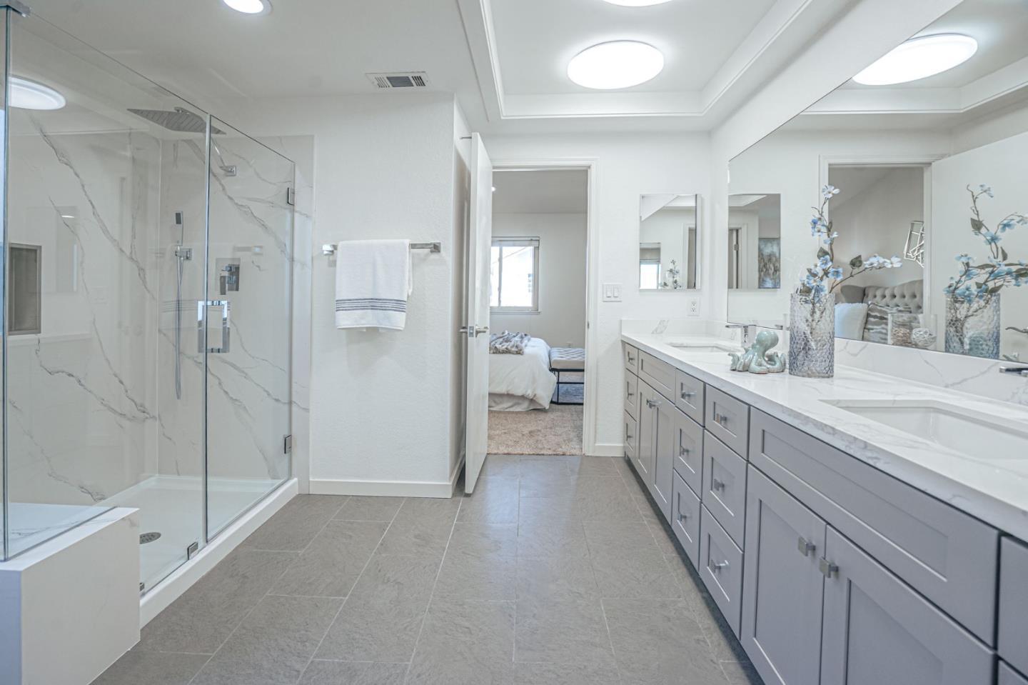 847 Pacheco Drive Milpitas, CA 95035 - Photo 49 of 68 a bathroom with a double vanity sink a mirror and a bathtub