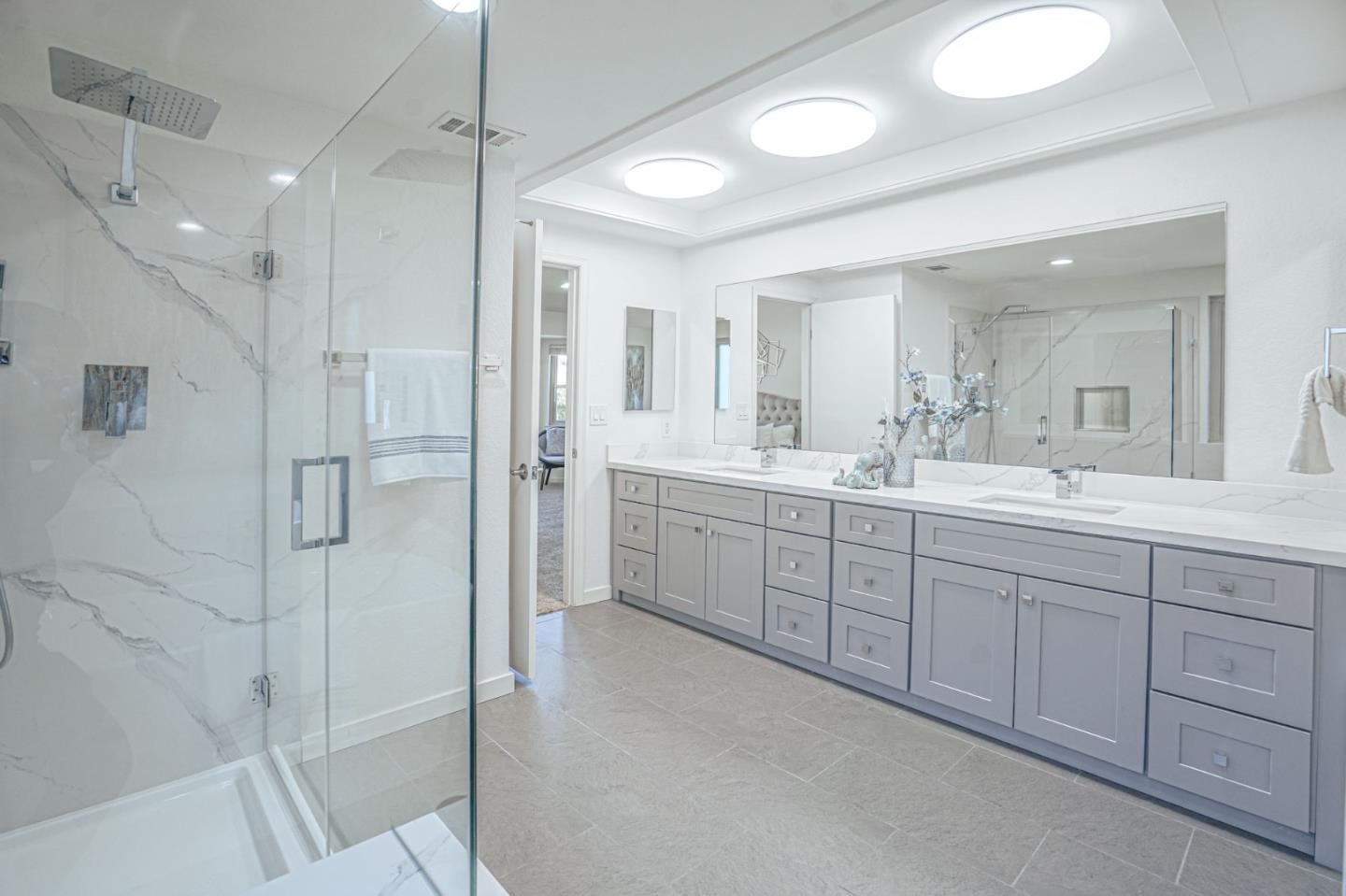 847 Pacheco Drive Milpitas, CA 95035 - Photo 52 of 68 a spacious bathroom with a shower sink and mirror