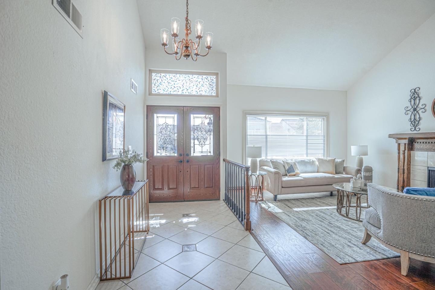 847 Pacheco Drive Milpitas, CA 95035 - Photo 6 of 68 a living room with furniture a fireplace and a chandelier
