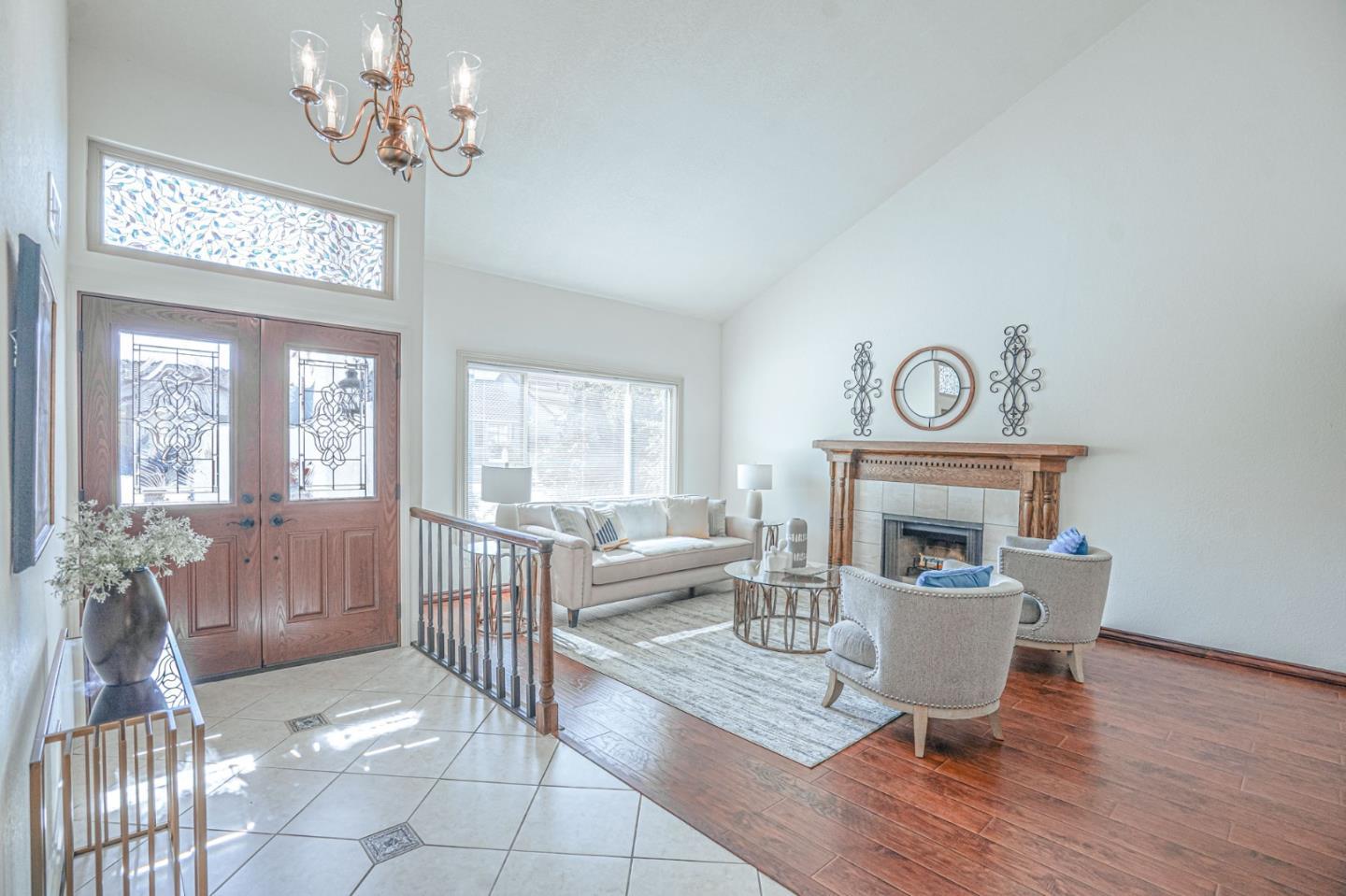 847 Pacheco Drive Milpitas, CA 95035 - Photo 8 of 68 a living room with furniture a chandelier and a fireplace
