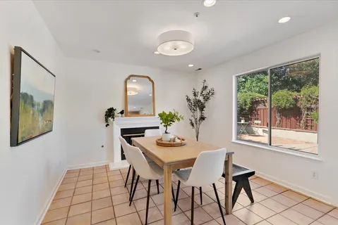 a dining room with furniture and window