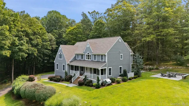 a aerial view of a house with garden and trees