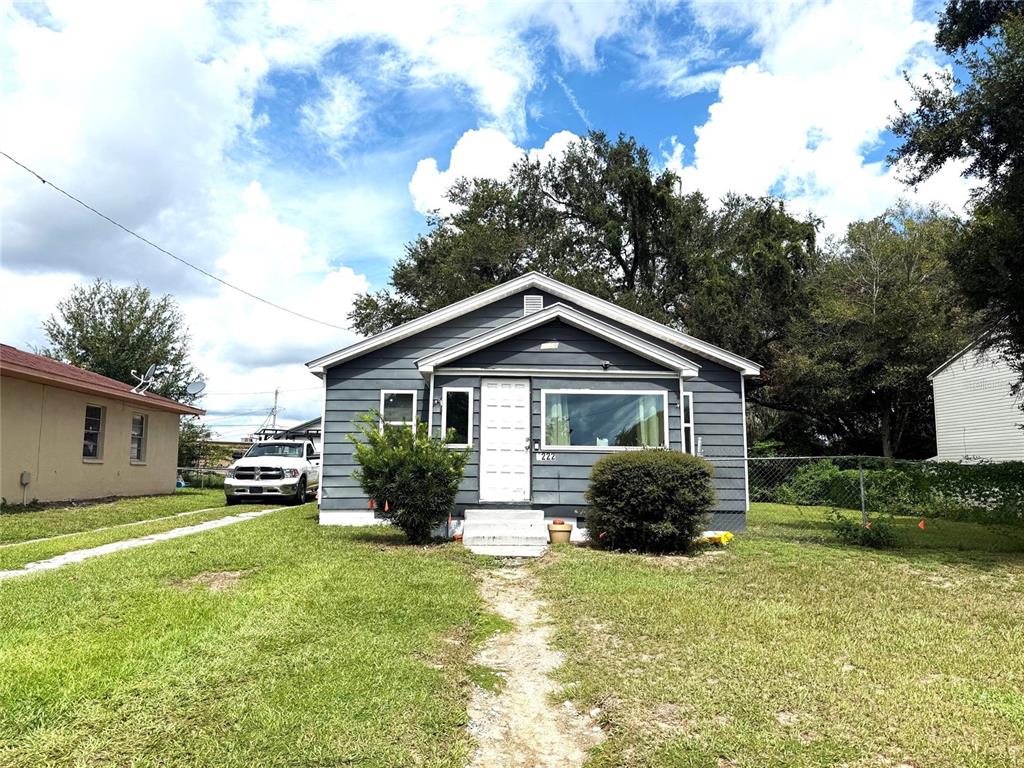 1222 Golconda Road Lakeland, FL 33801 - Photo 1 of 12 a front view of a house with yard and green space