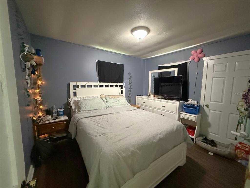 1222 Golconda Road Lakeland, FL 33801 - Photo 8 of 12 a bedroom with a bed and a flat tv screen on dresser