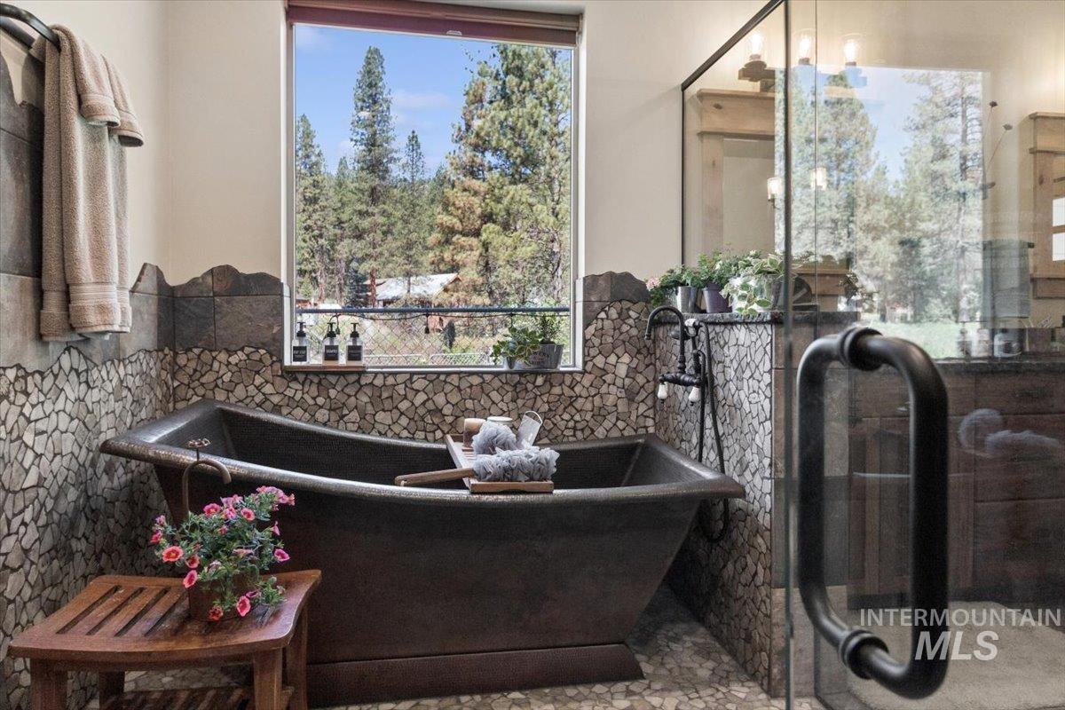 36 Kevins Way Garden Valley, ID 83622 - Photo 23 of 50 Bathroom featuring tiled shower, double vanity, healthy amount of natural light, stone tile floors, and recessed lighting