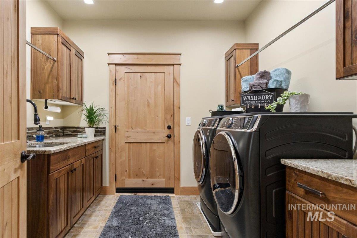 36 Kevins Way Garden Valley, ID 83622 - Photo 26 of 50 Laundry area featuring cabinet space and washing machine and dryer