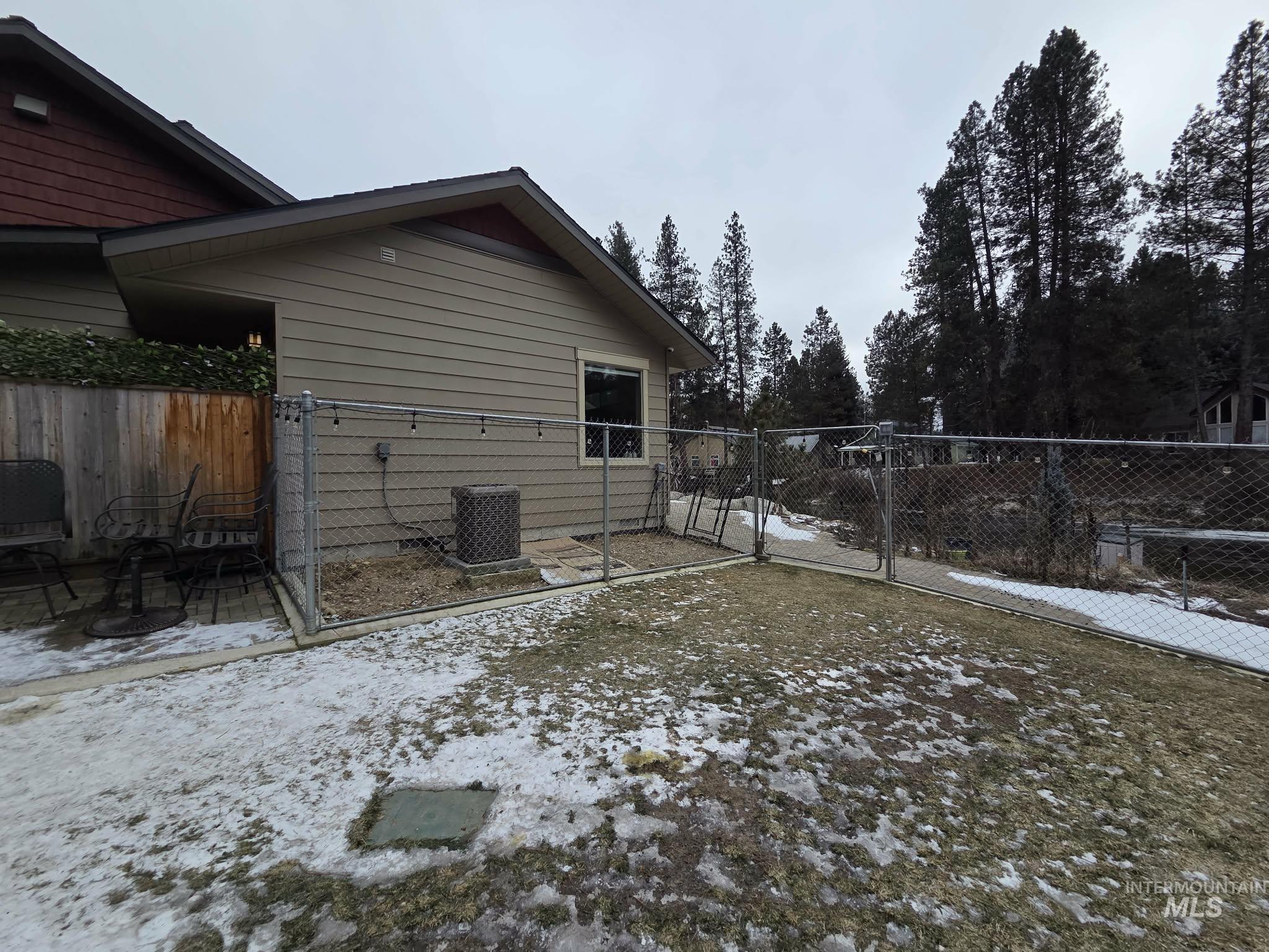 36 Kevins Way Garden Valley, ID 83622 - Photo 10 of 50 View of snow covered exterior with a gate and a central AC unit