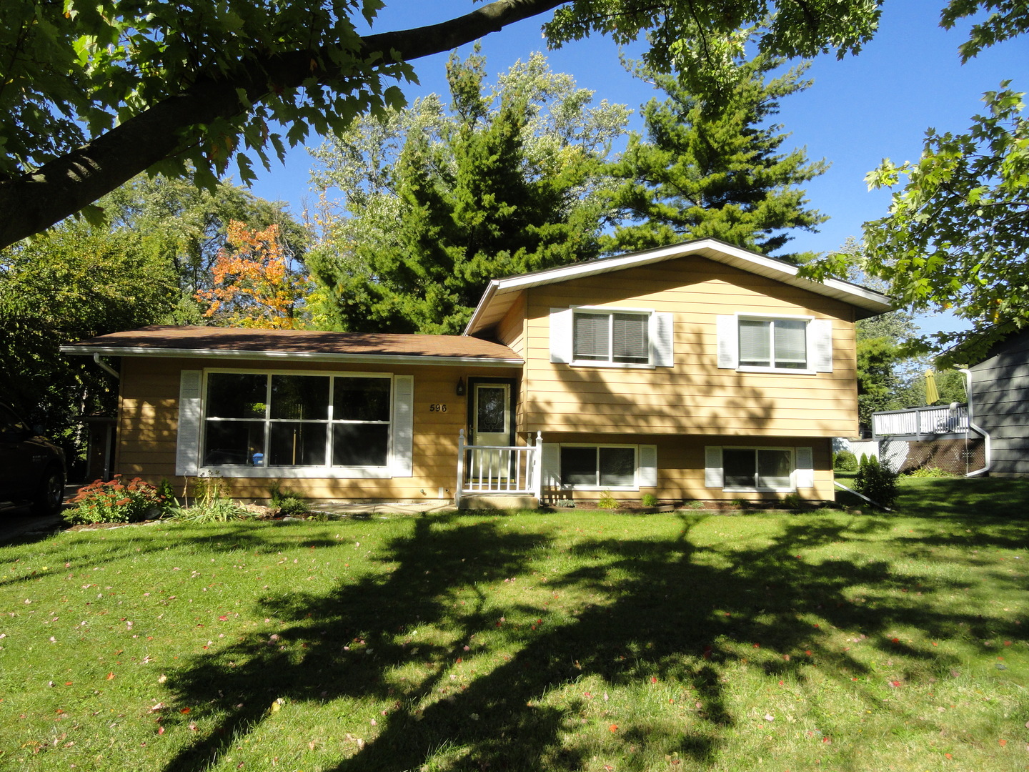 596 Maple Avenue Lisle, IL 60532 - Photo 1 of 21 a front view of a house with a yard and trees