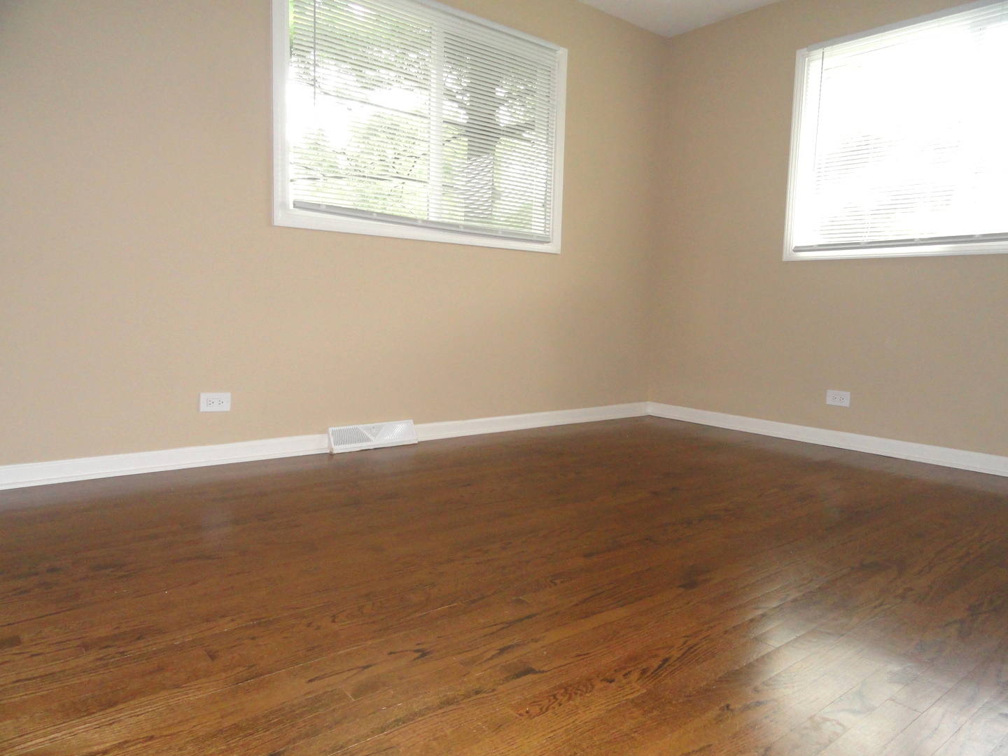 596 Maple Avenue Lisle, IL 60532 - Photo 12 of 21 an empty room with wooden floor and windows