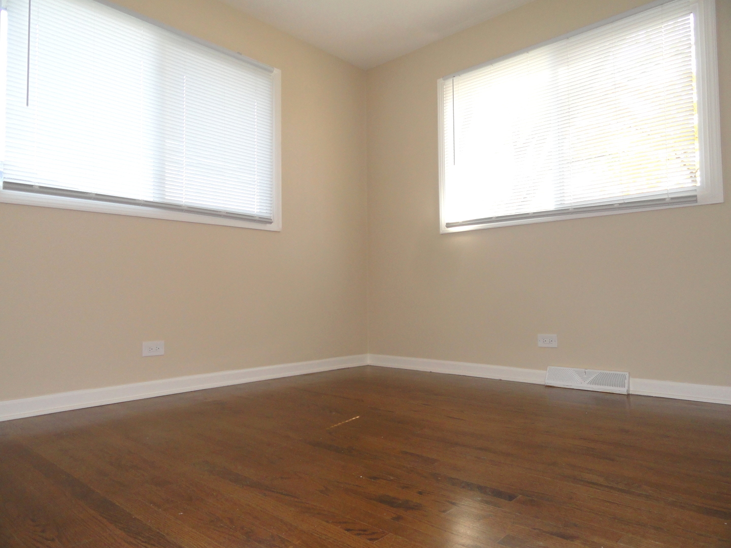 596 Maple Avenue Lisle, IL 60532 - Photo 17 of 21 an empty room with wooden floor and windows