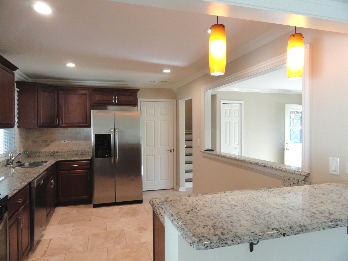 596 Maple Avenue Lisle, IL 60532 - Photo 5 of 21 a kitchen with stainless steel appliances granite countertop a sink a stove and a refrigerator