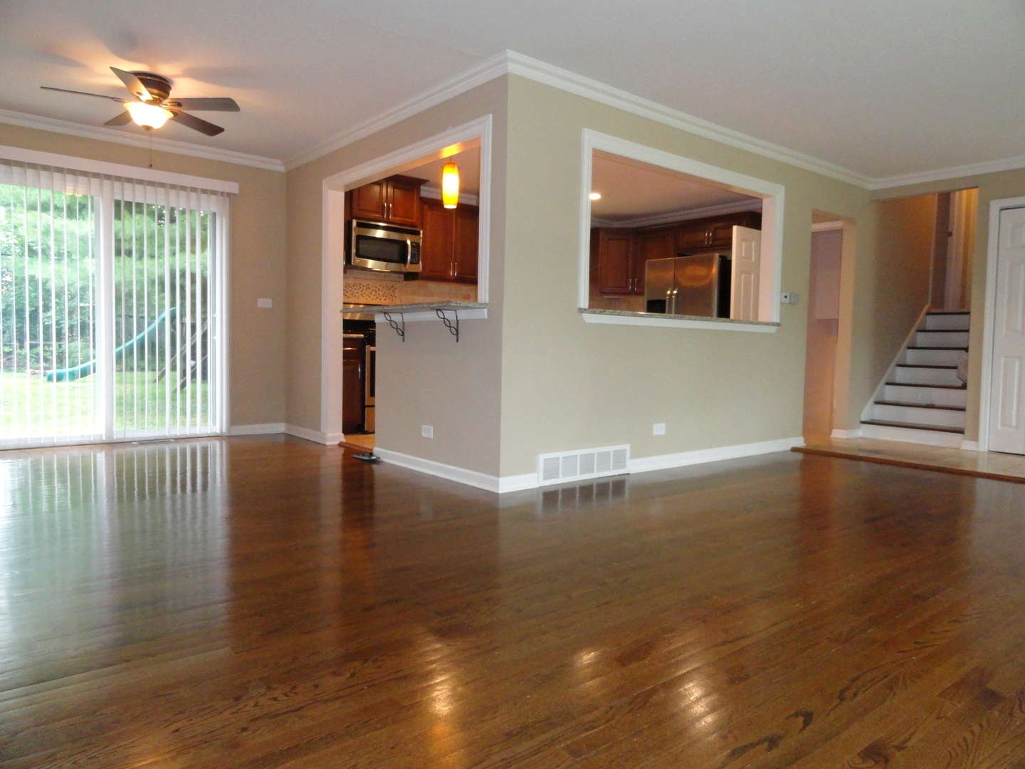 596 Maple Avenue Lisle, IL 60532 - Photo 6 of 21 a view of an empty room with wooden floor and a window