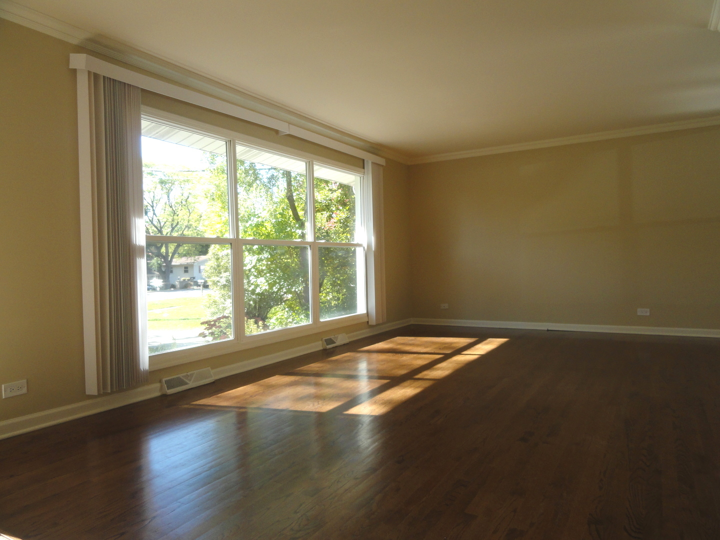 596 Maple Avenue Lisle, IL 60532 - Photo 8 of 21 a view of an empty room with wooden floor and a window
