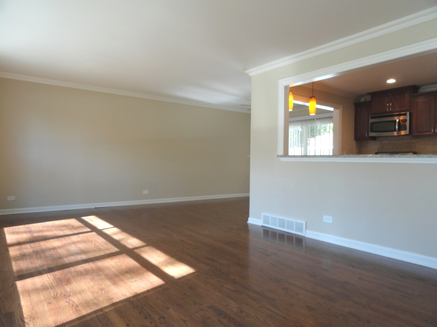 596 Maple Avenue Lisle, IL 60532 - Photo 9 of 21 an empty room with wooden floor and windows