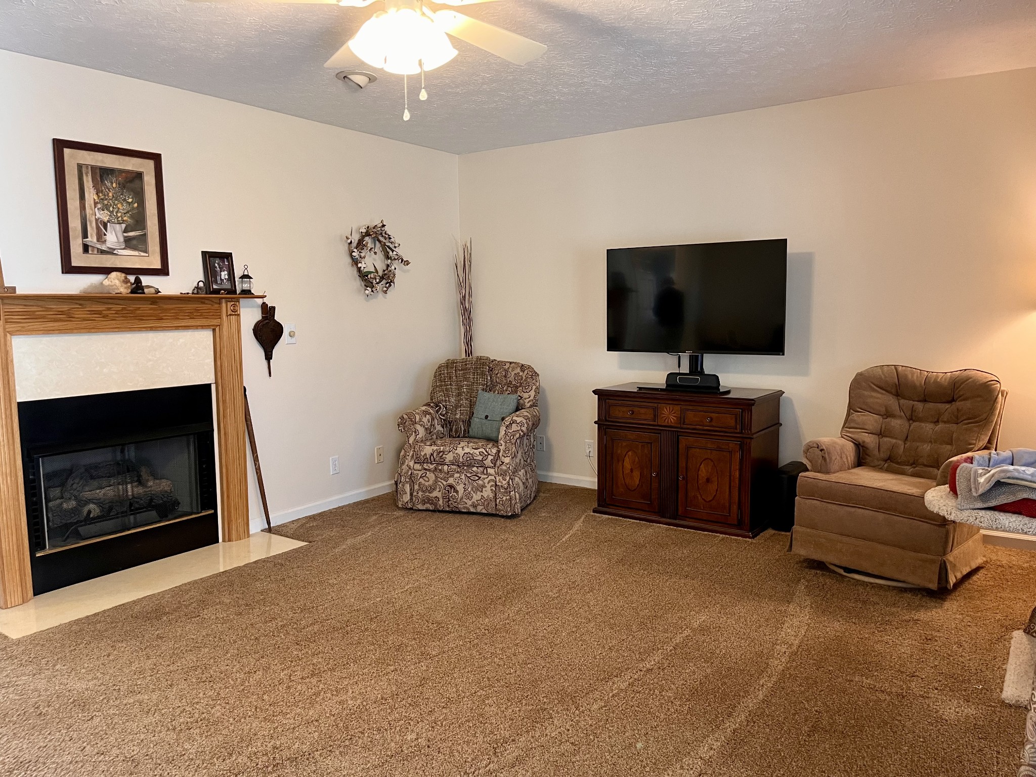 4869 Starks Road Cross Plains, TN 37049 - Photo 6 of 46 a living room with furniture a flat screen tv and a fireplace