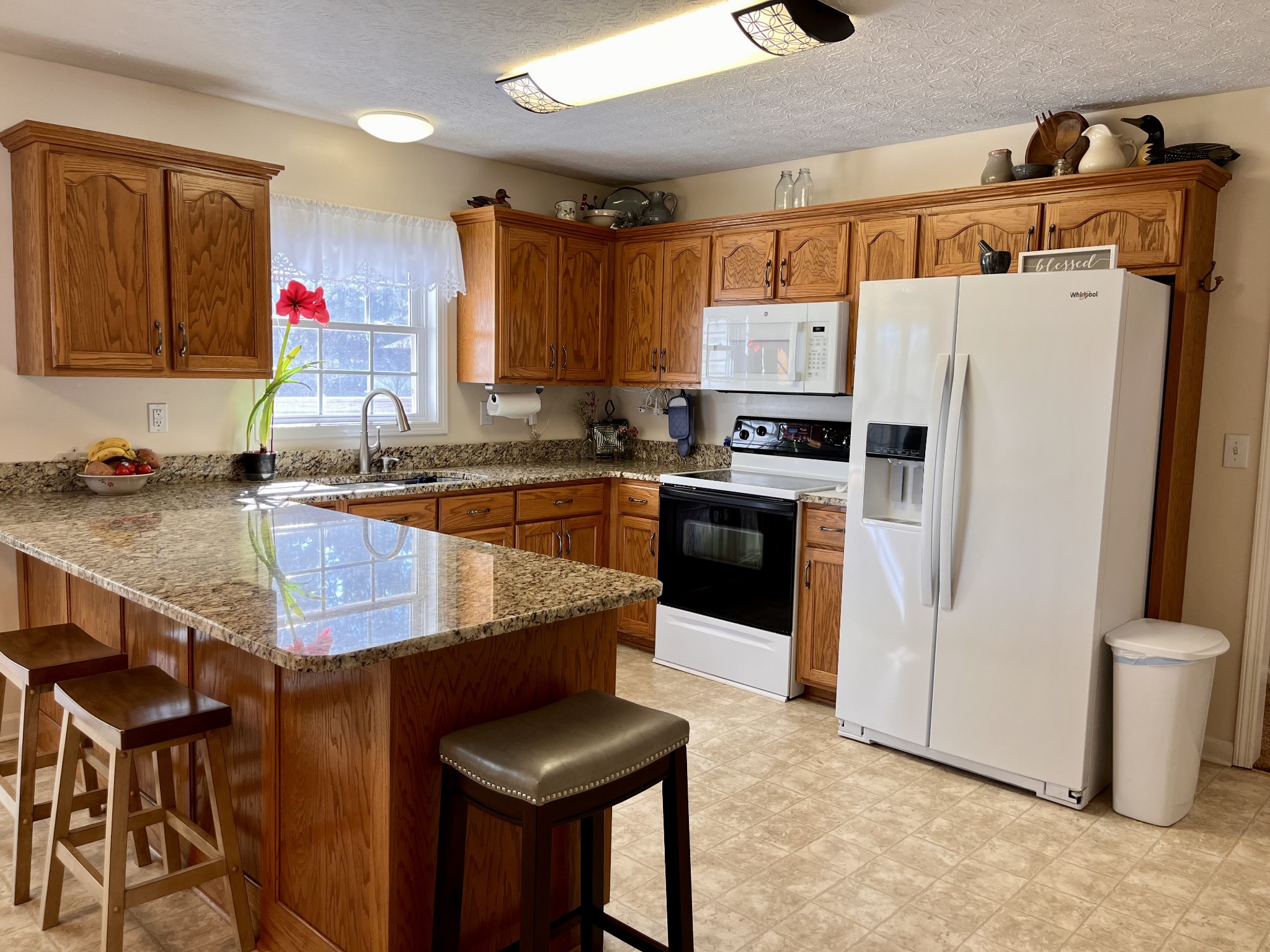 4869 Starks Road Cross Plains, TN 37049 - Photo 8 of 46 a kitchen with stainless steel appliances granite countertop a sink refrigerator and microwave