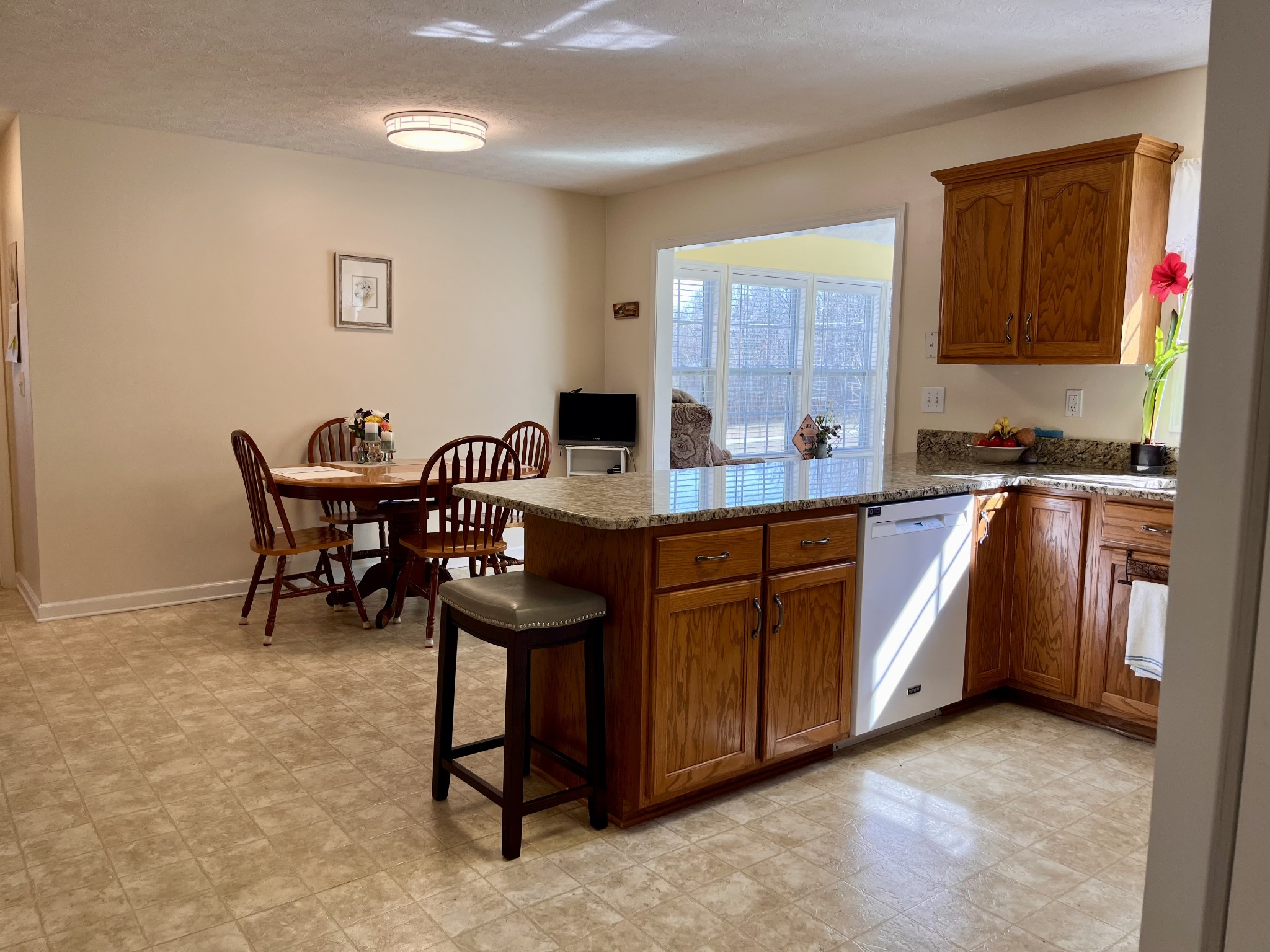 4869 Starks Road Cross Plains, TN 37049 - Photo 9 of 46 a kitchen with stainless steel appliances granite countertop a sink a stove a refrigerator cabinets and dining table