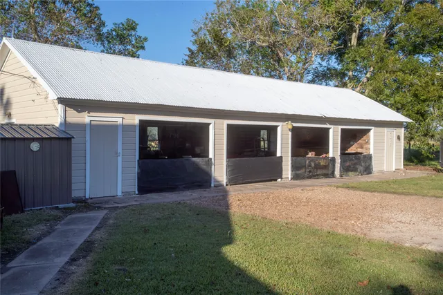 a front view of a house with a garden and yard