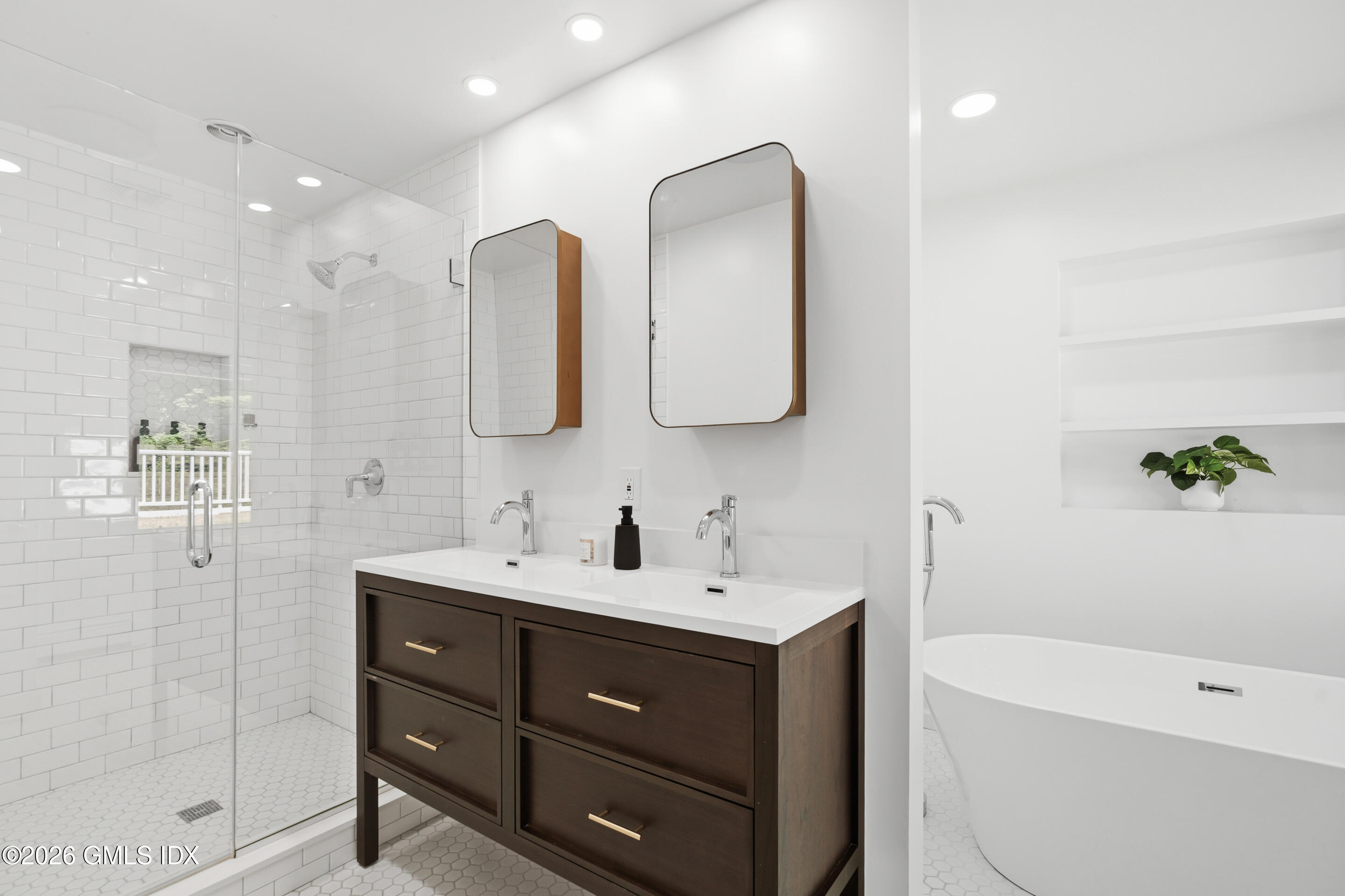 33 Sachem Road Greenwich, CT 06830 - Photo 12 of 35 a bathroom with a double vanity sink mirror and bathtub