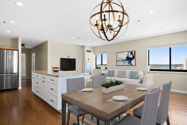 a living room with furniture a chandelier and a flat screen tv