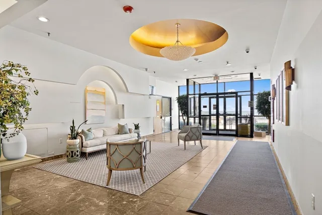 a dining room with chandelier fan and wooden floor