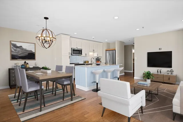 a bathroom with a granite countertop toilet a sink and shower