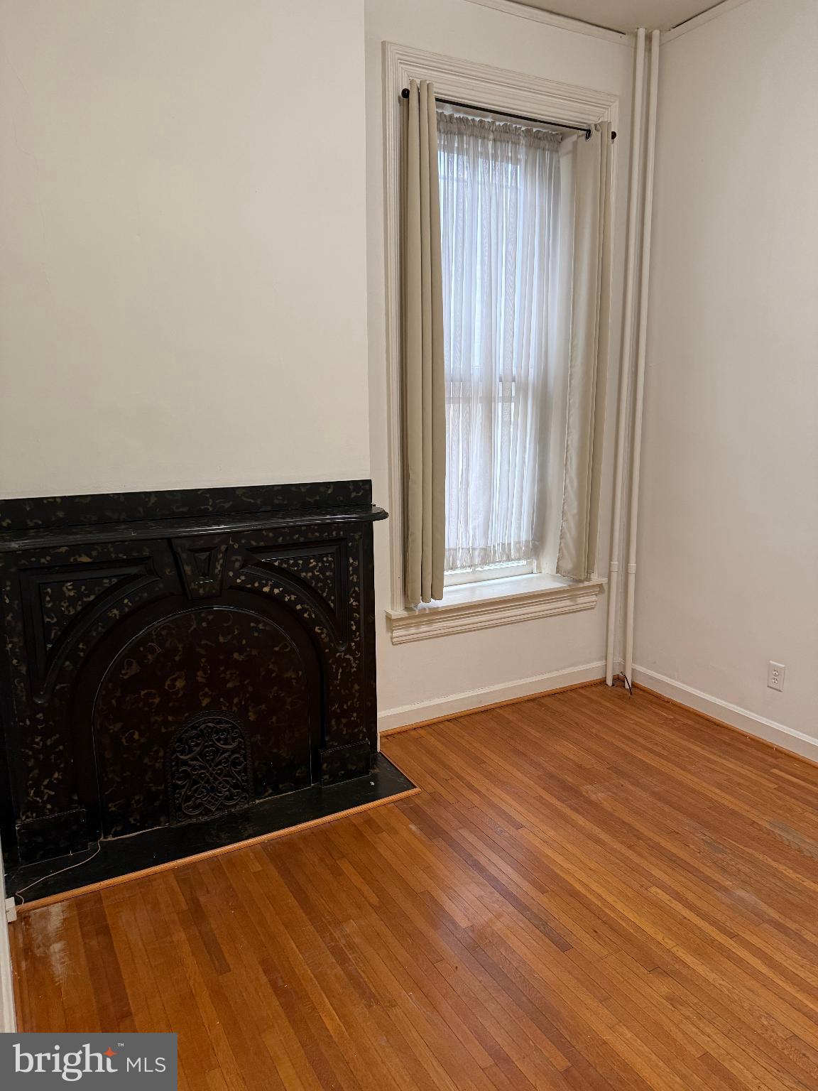 232 West Main Street, Unit 4 Waynesboro, PA 17268 - Photo 3 of 12 a view of an empty room with wooden floor and a window