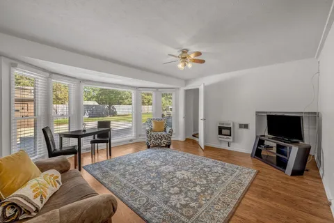 a front view of a house with a yard and trees