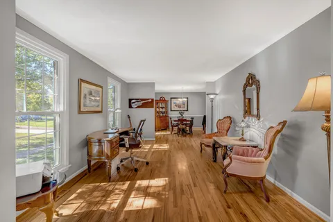 a bathroom with a granite countertop sink toilet and mirror