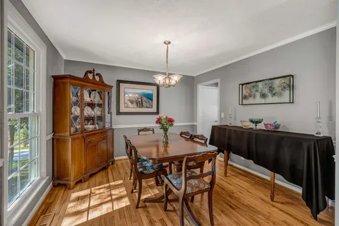 a bathroom with a granite countertop sink a toilet and a mirror