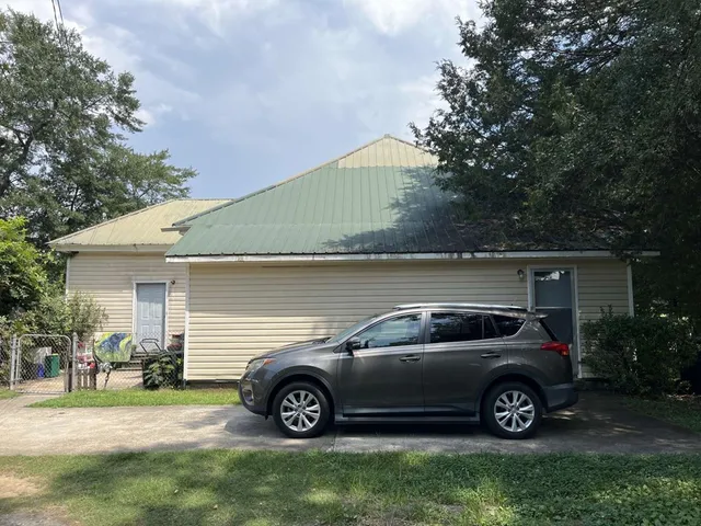 a view of a car in front of a house