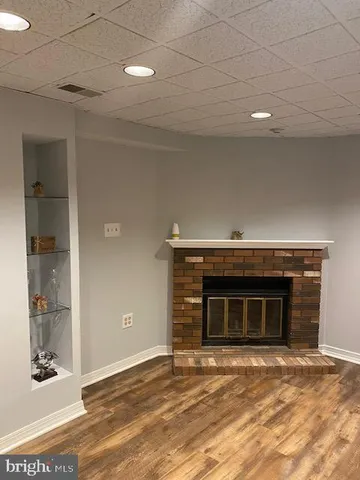 a view of an empty room with window and fire place