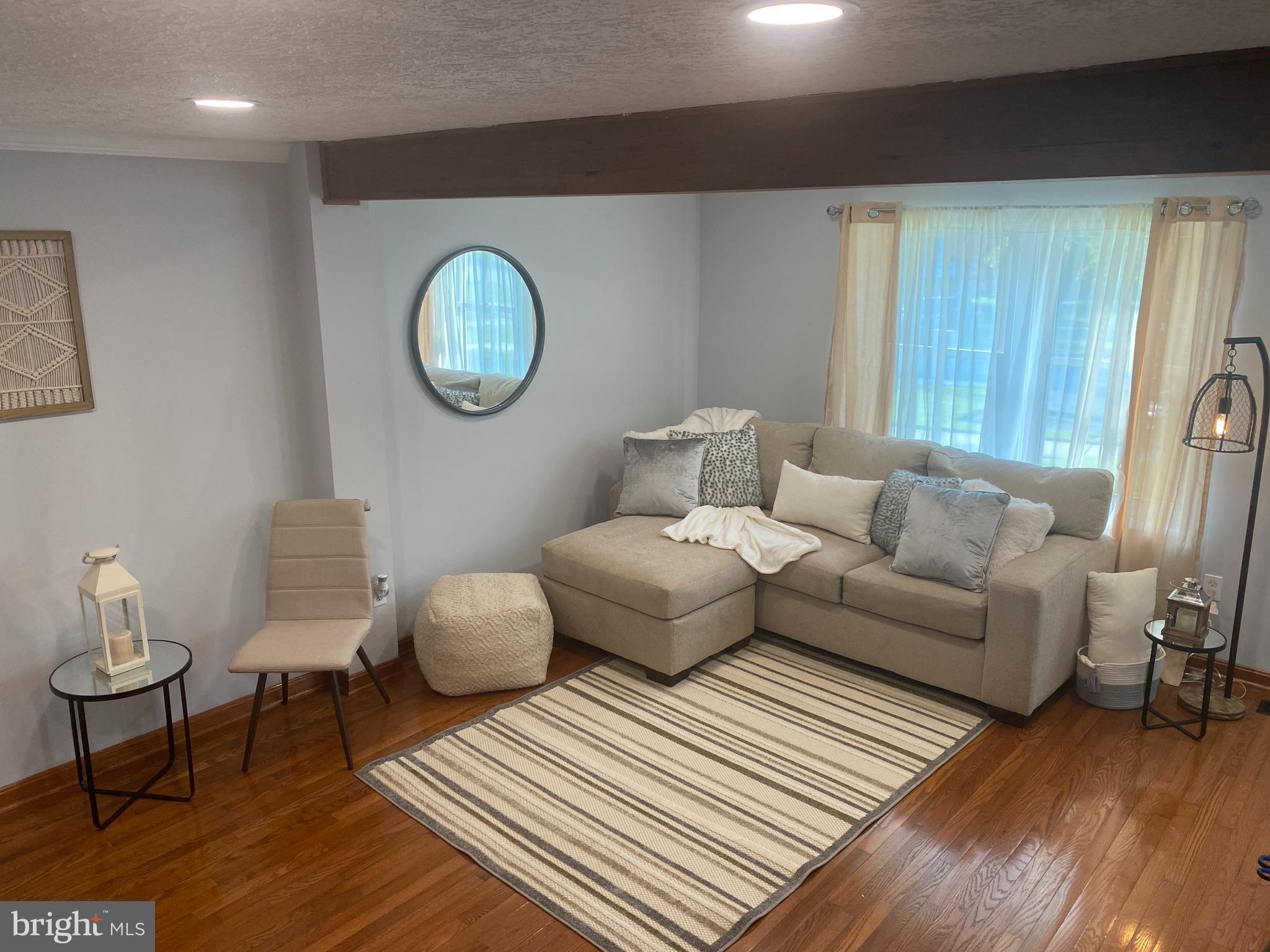 7 Capland Court Perry Hall, MD 21128 - Photo 4 of 7 a living room with furniture a rug and a window