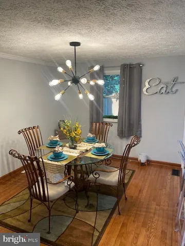 a dining room with furniture and wooden floor