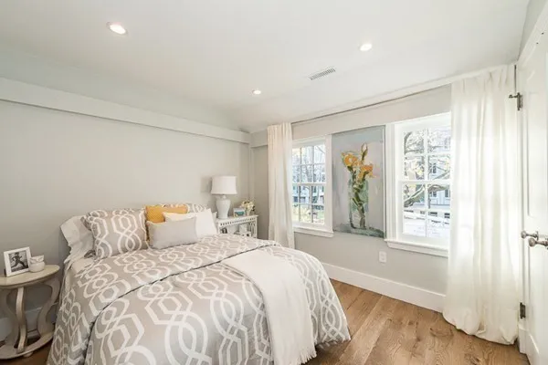 a bedroom with a large bed and a large window