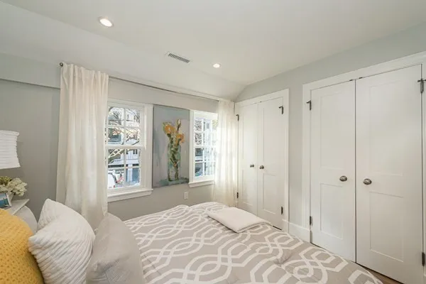 a bedroom with a large bed and a window