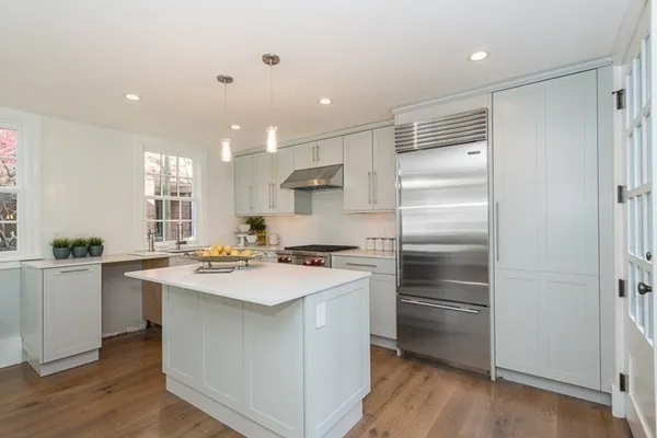 a kitchen with a refrigerator stove and sink