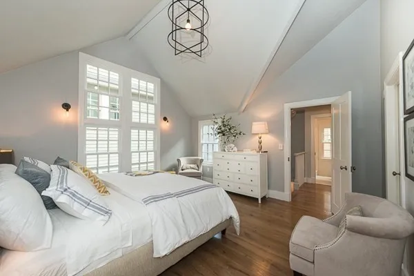 a bedroom with a bed and window