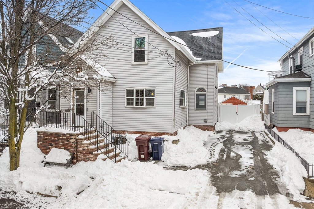 34 Paris Street Everett, MA 02149 - Photo 1 of 25 a view of a house with snow on roof